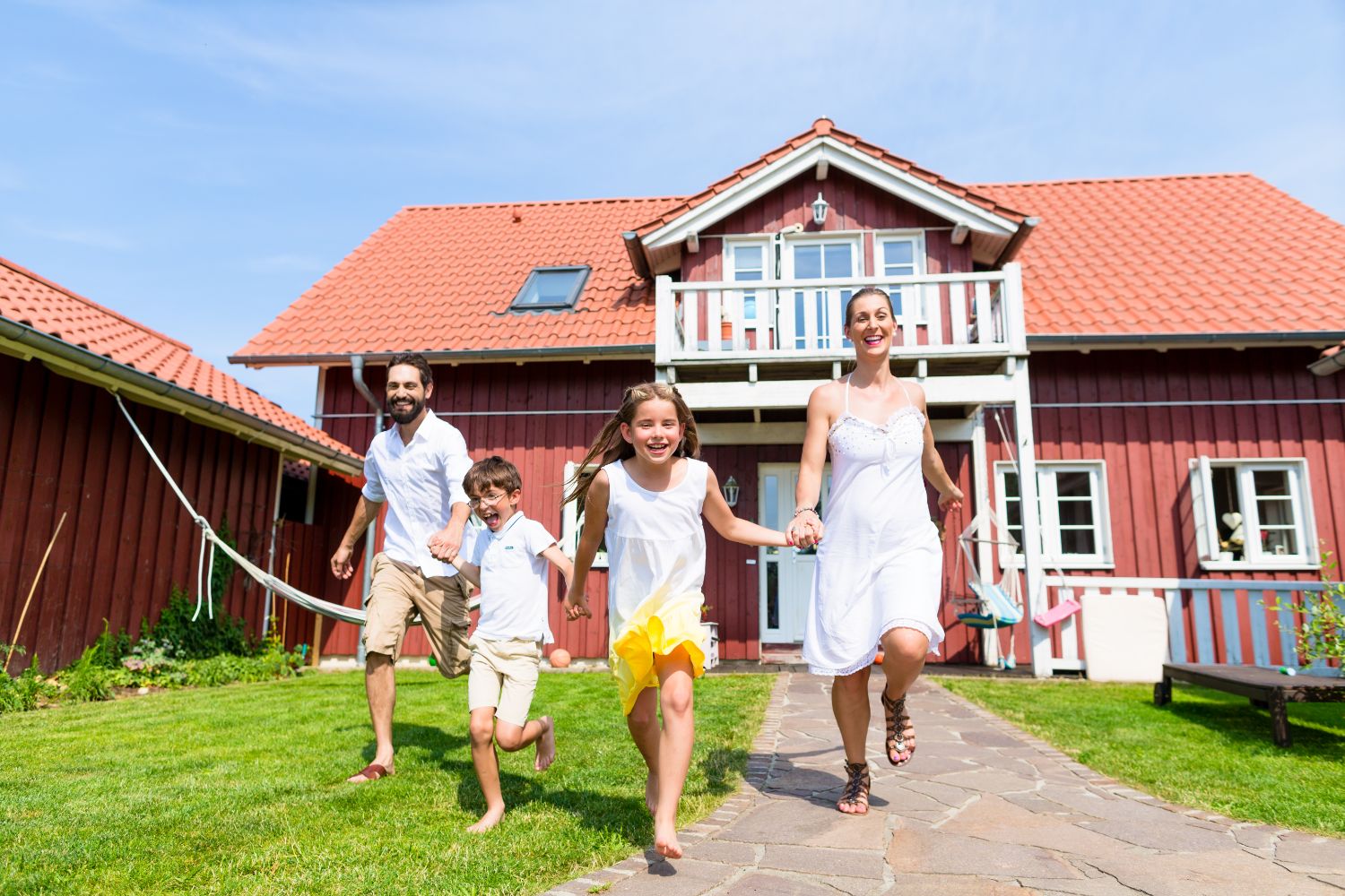 family_running_yard Family with children running in front of house